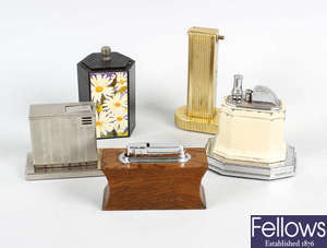 A large collection of table and pocket cigarette lighters