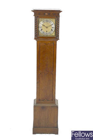 An early 20th century oak-cased chiming grandmother clock