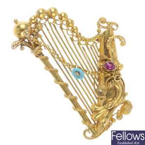 A mid 19th century gold gem-set sentimental harp brooch.