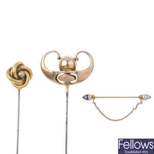 Two late 19th century gold hatpins and an early 20th century gold synthetic sapphire dress pin. 