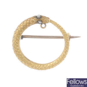 A mid 19th century gold and diamond ouroboros snake brooch. 