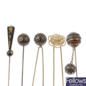 A selection of late 19th to early 20th century hatpins and hair combs.