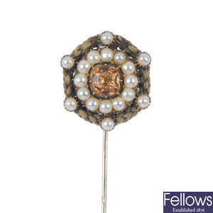 A late 19th century foil back topaz, split pearl and hair mourning stickpin.