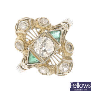 A diamond and emerald dress ring. 