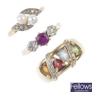 A selection of three gold gem-set rings.