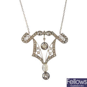 An early 20th century silver and gold diamond and seed pearl pendant. 