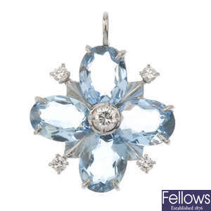 An aquamarine and diamond flower pendant.