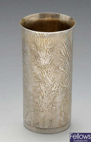 A silver vase or beaker.