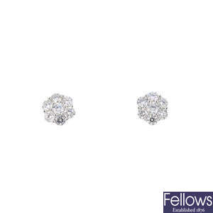 A pair of diamond floral cluster stud earrings.