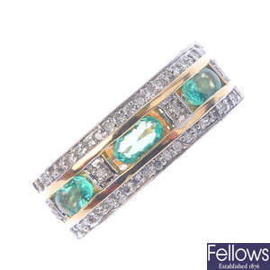 A 14ct gold emerald and diamond band ring.