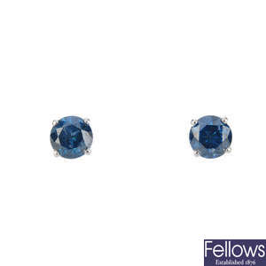 A pair of colour treated 'blue' brilliant-cut diamond stud earrings.