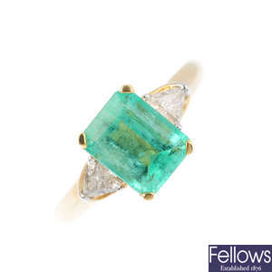 A 14ct gold emerald and diamond three-stone ring.