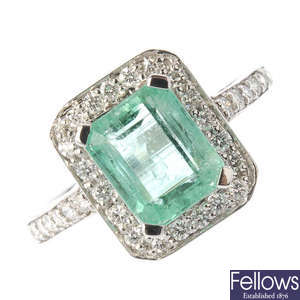 A 14ct gold emerald and diamond cluster ring.