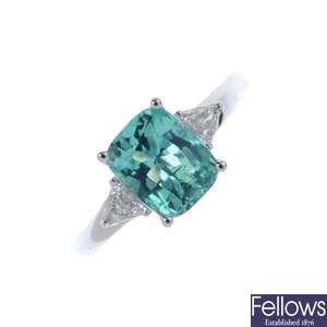 A platinum Colombian emerald and diamond three-stone ring.