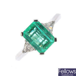 An 18ct gold Columbian emerald and diamond three-stone ring.