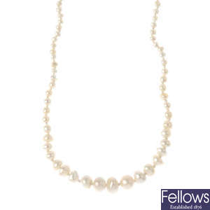 An early 20th century natural pearl single-strand necklace, with diamond clasp.