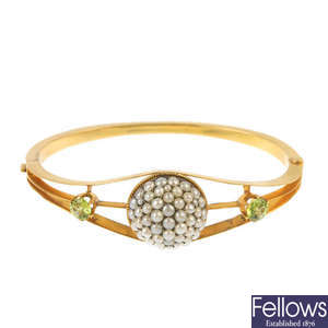 An early 20th century 15ct gold split pearl and peridot bangle.
