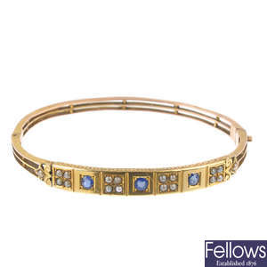 A late Victorian 9ct gold sapphire and split pearl bangle.