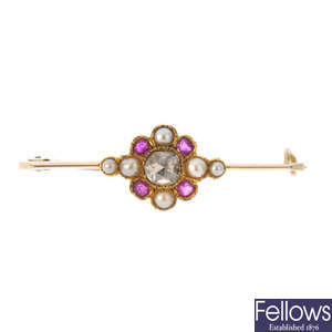 An early 20th century 15ct gold diamond, ruby and split pearl brooch.