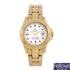 ROLEX - a lady's 18ct yellow gold Oyster Perpetual Date Yacht-Master bracelet watch.