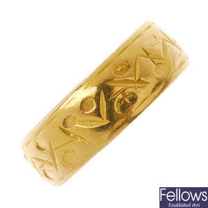 A 22ct gold textured band ring.
