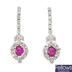 A pair of ruby and diamond ear pendants.
