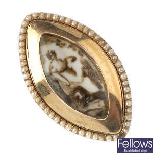 An early 19th century gold ivory and seed pearl mourning ring.
