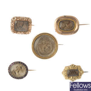 A selection of five early to mid 19th century gold mourning brooches.