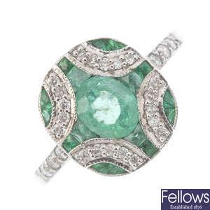 An emerald and diamond dress ring.