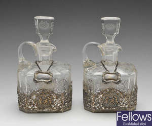 A pair of 1920's silver mounted cut-glass decanters.