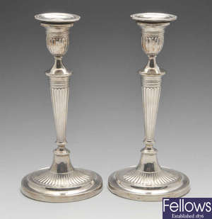A pair of late Victorian silver candlesticks.
