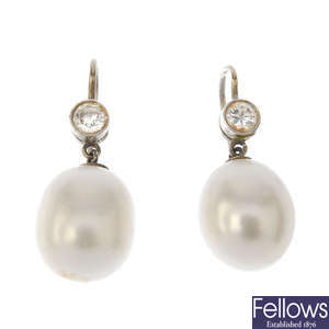 A pair of freshwater cultured pearl and diamond ear pendants.