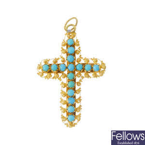 A turquoise cross pendant.