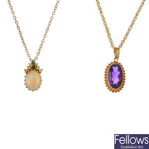 A selection of four gem-set pendants and chains.