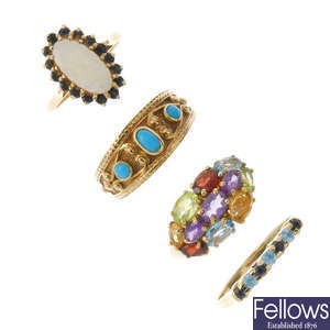 A selection of four 9ct gold gem-set rings.