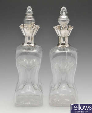 A pair of late Victorian Scottish silver mounted 'glug glug' decanters.