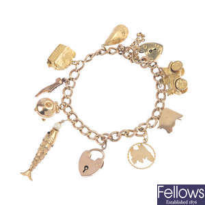 A 9ct gold curb-link bracelet, suspending a series of nine charms.