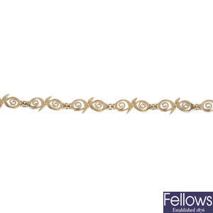 A 9ct gold scrolling bracelet and earrings.