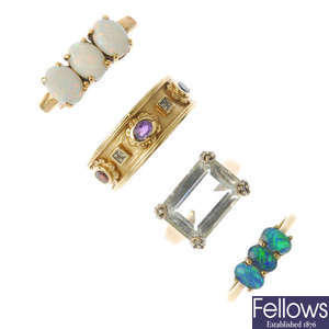 A selection of four 9ct gold gem-set and diamond rings.