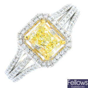 A Fancy Light Yellow diamond and diamond cluster ring.