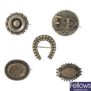 Fifteen late 19th to early 20th century silver brooches.