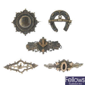 Fourteen late 19th to early 20th century silver brooches.