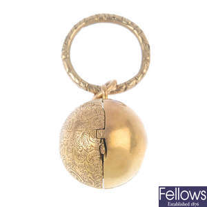 A late Victorian gold locket and late Georgian gold suspension loop.