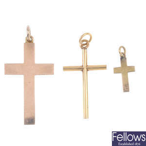 Four cross pendants and a chain.