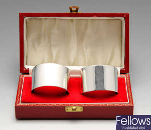 A cased pair of 1970's silver napkin rings, etc.