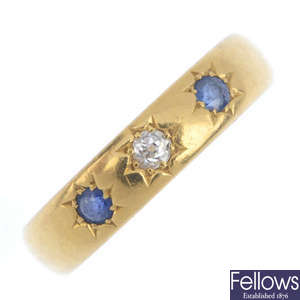 A late Victorian 22ct gold diamond and sapphire three-stone band ring.