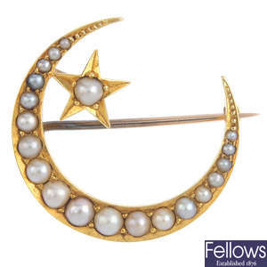A late Victorian gold split pearl star and crescent moon brooch, circa 1900.