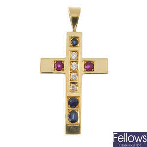 A diamond and gem-set cross pendant.