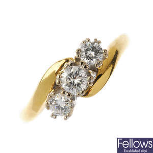 An 18ct gold diamond three-stone crossover ring.