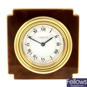 A gold plated desk clock by Cartier.